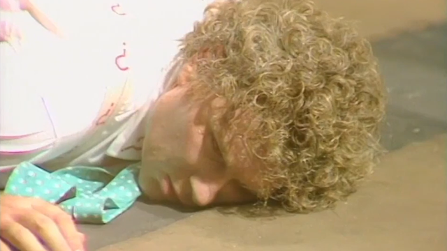 The Doctor dies of heat exhaustion in 'Vengeance on Varos'... or does he? (No, he doesn't) (c) BBC Studios Sixth Doctor Colin Baker cliffhanger